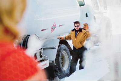 Man with Jacket in Snow with Propane